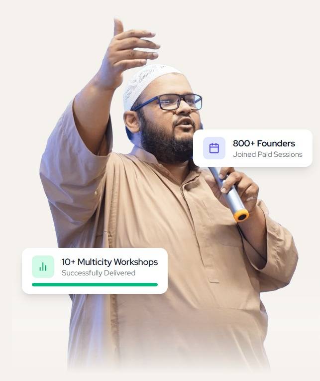 Omer Sharif on stage, speaking to a crowd of founders and entrepreneurs
